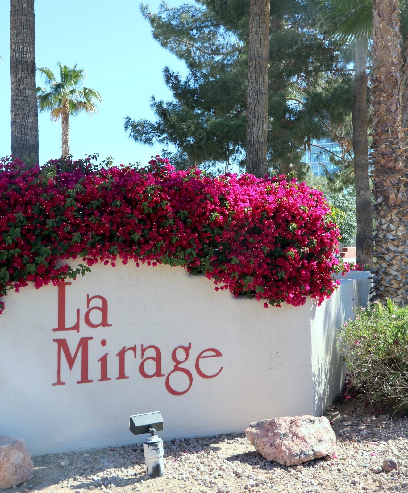 The La Mirage monument sign under bougainvillea